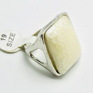 Pearlescent faux stone set in silver tone ring